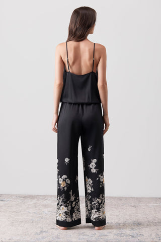 Back side picture of a woman wearing a silk jumpsuit 