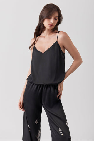 Woman wearing a jumpsuit - details of the V neck silk top with spaghetti straps