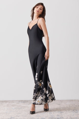 Woman 3/4 posing wearing a long silk dress with spaghetti straps in high heals and a white background- SHIKKOSA
