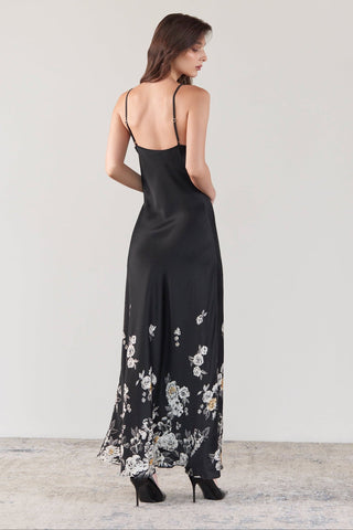 Back side of a woman wearing a long silk dress with spaghetti straps in high heals and a white background - SHIKKOSA