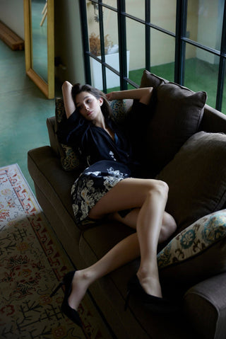 Woman wearing a silk kimono laying on a sofa