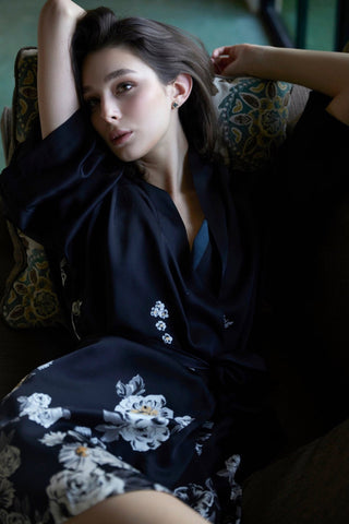 Detail zoom in pictures of a woman wearing a silk kimono and laying on a sofa