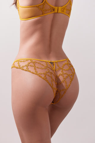 Yellow lace lingerie set on a plain background