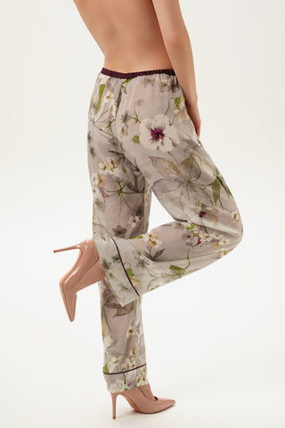 Floral printed silk chiffon pajama pants worn by a woman on a white background